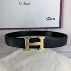 Black pebbled leather belt with gold H-style buckle, single loop keeper at center