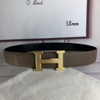 Leather belt with gold H buckle, textured strap, and single-prong keeper