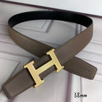 Leather belt with large gold H buckle and textured taupe strap