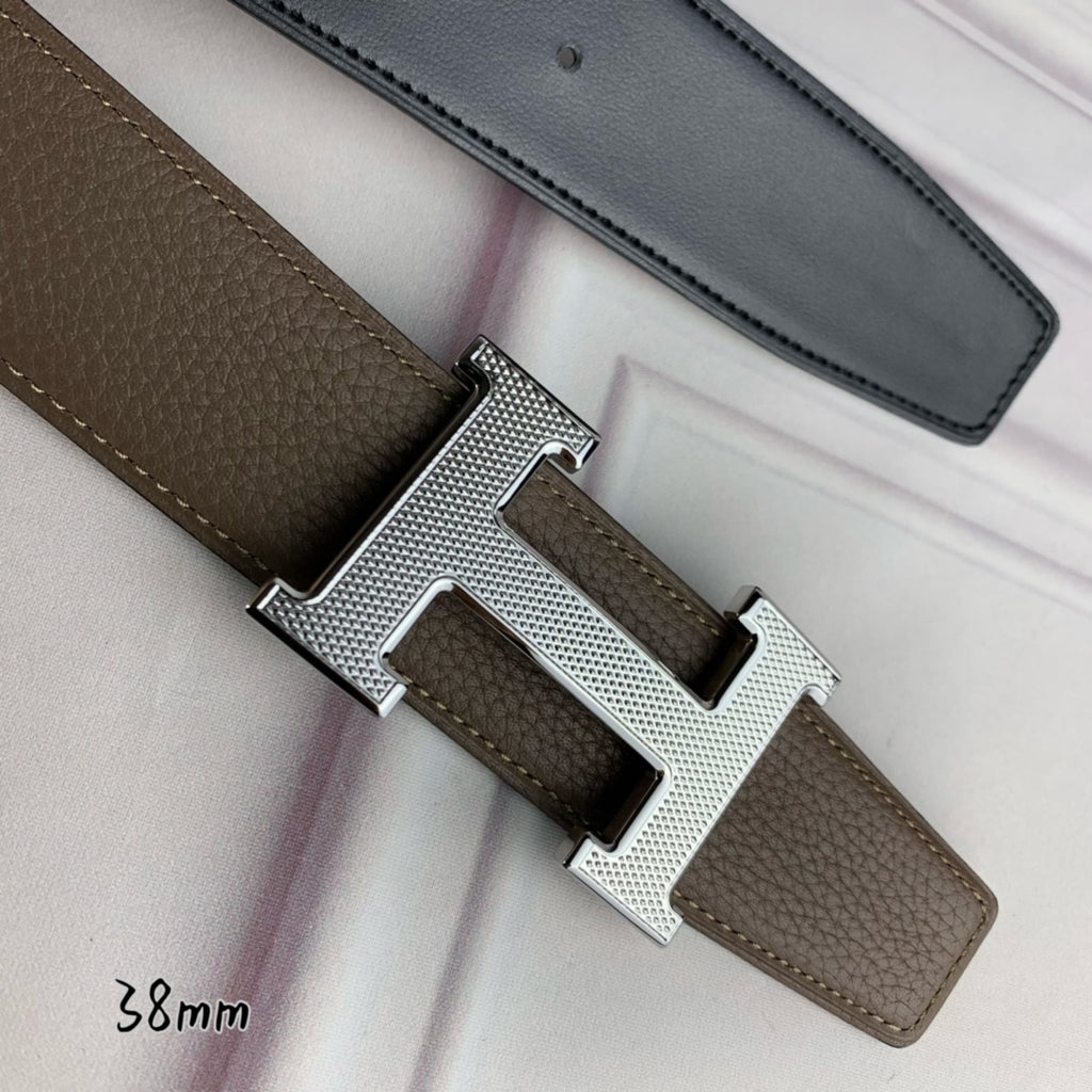 Leather belt with silver H buckle detail and textured strap close-up