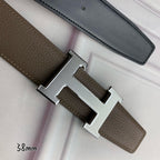 Leather belt with silver H buckle detail and textured strap close-up