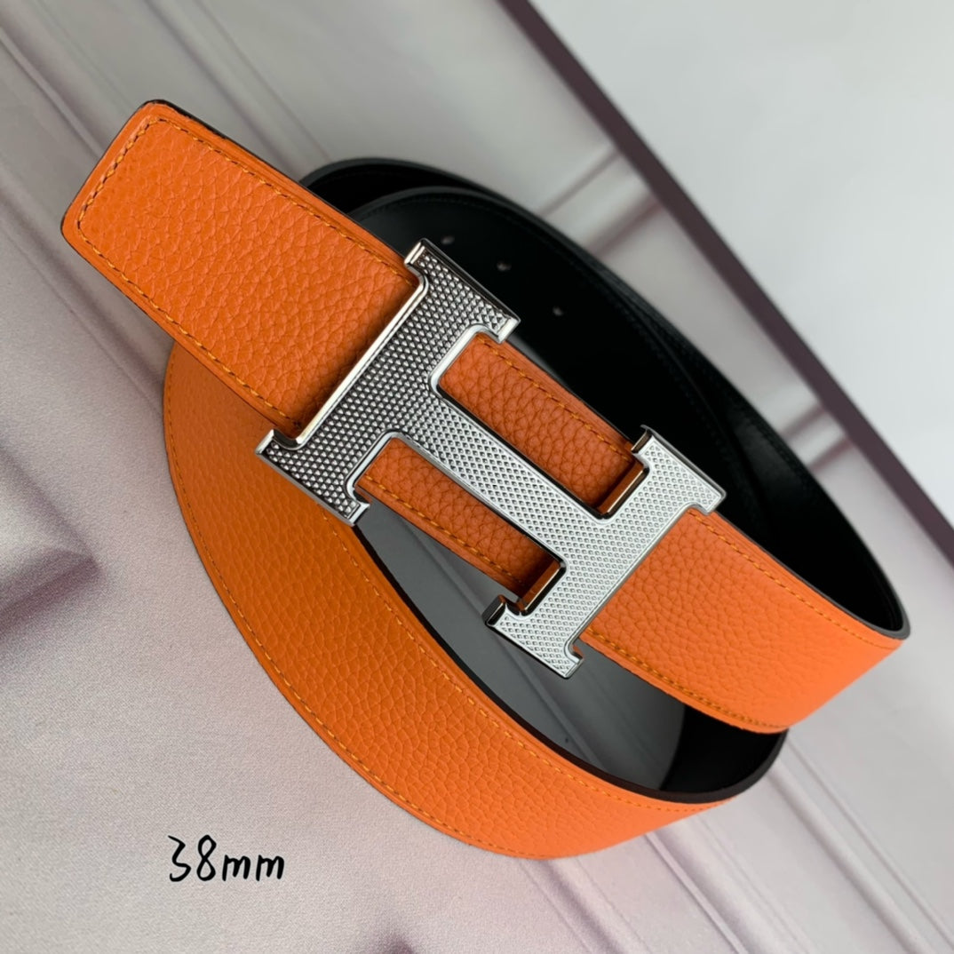 Orange leather belt with silver-tone H buckle, end tab visible