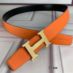 Orange leather belt with gold-tone H buckle detail and loop strap