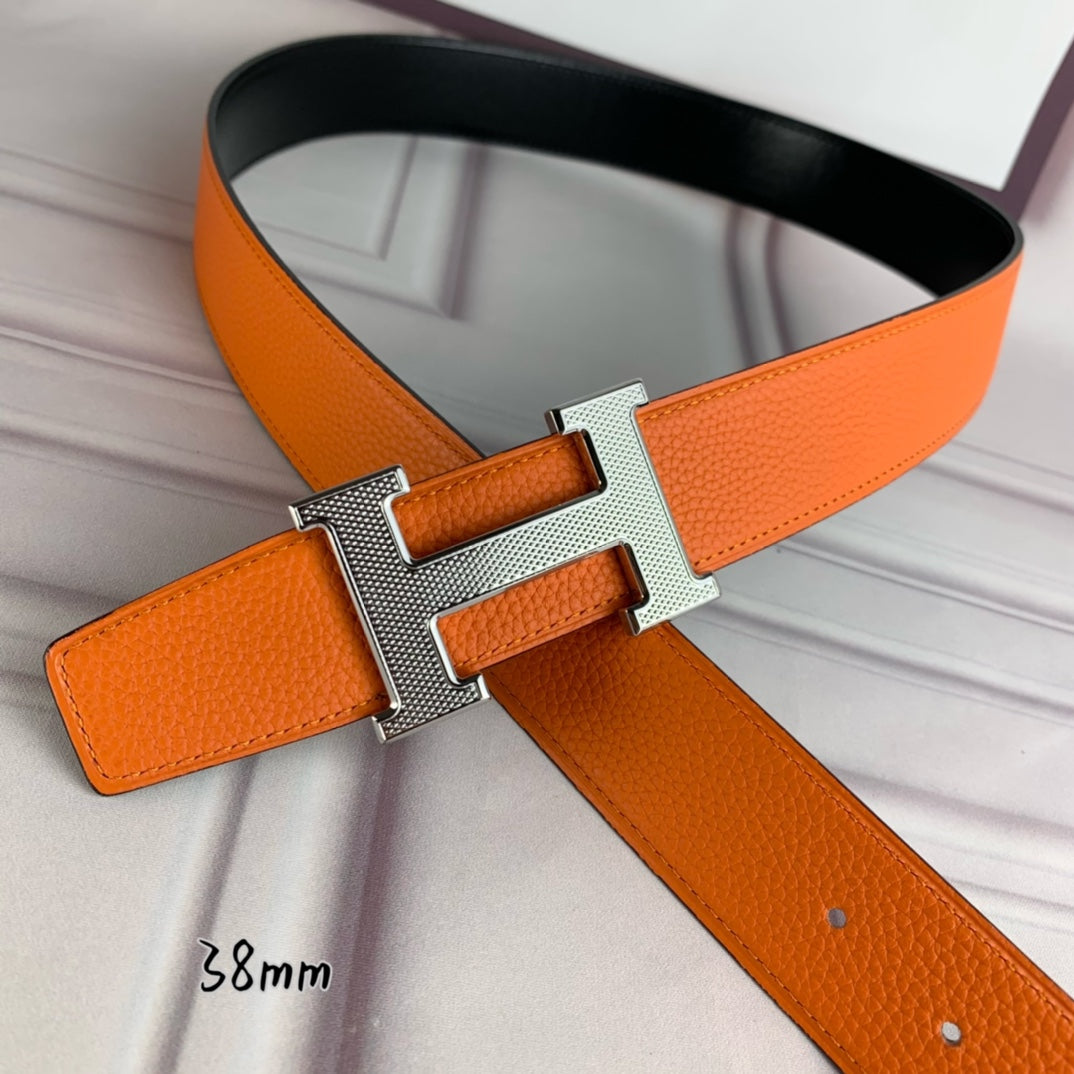 Orange leather belt with silver-tone H buckle and textured strap