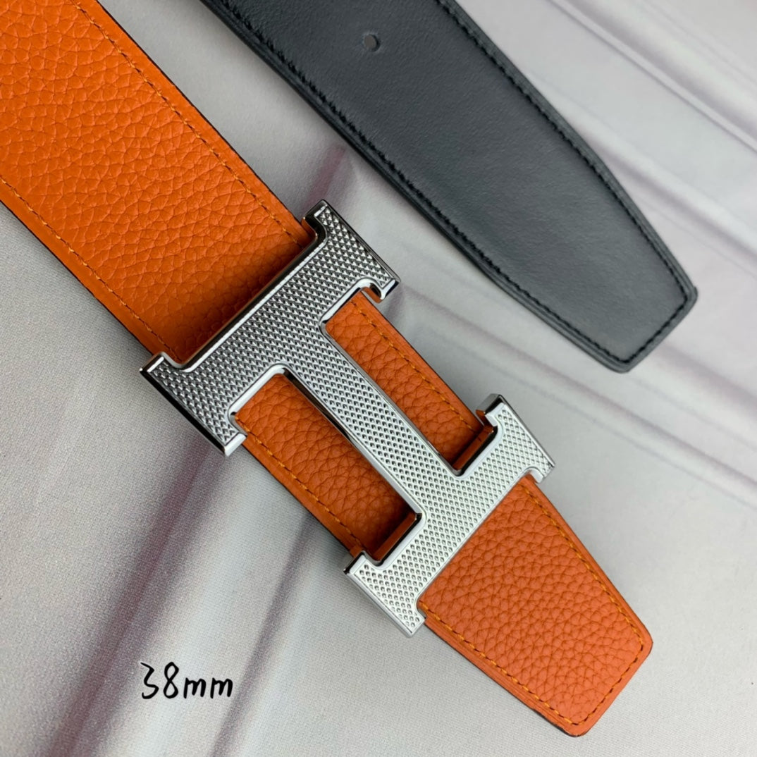 Orange leather belt with silver-tone H buckle, textured grain close-up