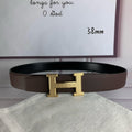 Hermes belt with gold H buckle and brown textured leather strap