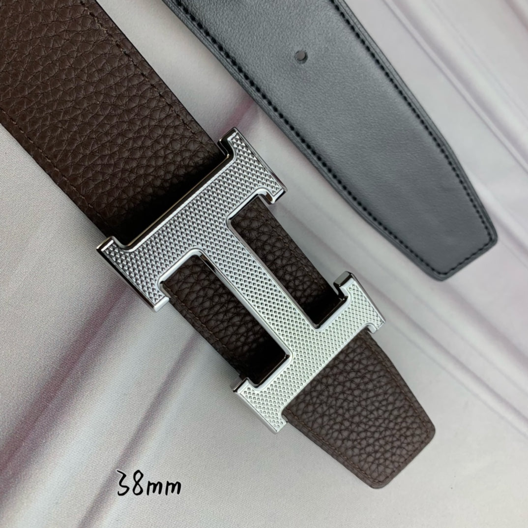 Hermes belt close-up: silver H buckle on brown textured strap