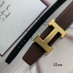 Hermes belt with gold H buckle on brown leather strap, leather keeper