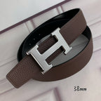 Hermes belt with silver H buckle on brown leather strap, black underside