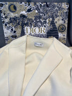 Cream long coat lapels with Dior label inside neckline