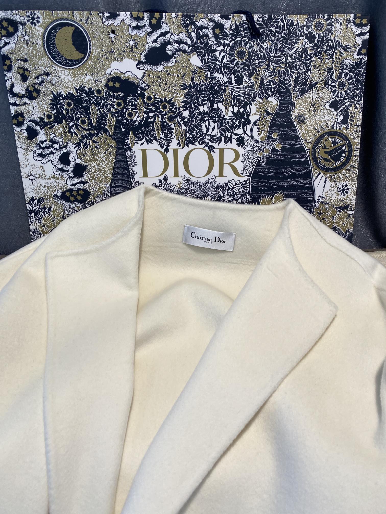 Cream long coat lapels with Dior label inside neckline