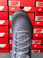 Basketball sneaker with light gray laces and textured dark upper, front view.