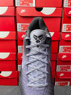 Basketball sneaker with dark gray mesh upper, light gray laces, lace-up tongue.