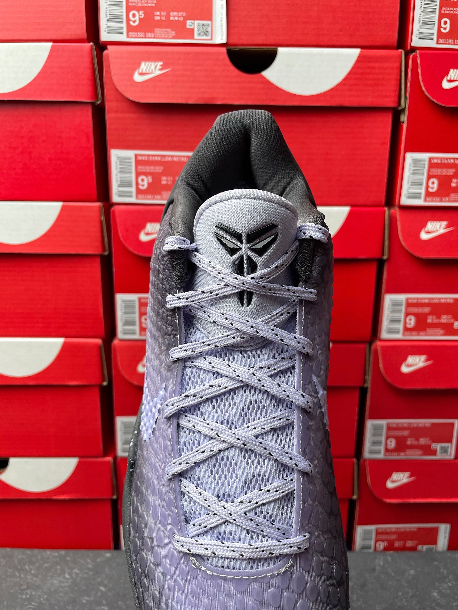 Basketball sneaker with dark gray mesh upper, light gray laces, lace-up tongue.