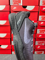 Basketball sneaker with textured dark gray upper and black outsole, lace-up front.