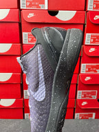 Basketball sneaker with dark gray and purple textured upper, lace-up design, side view.