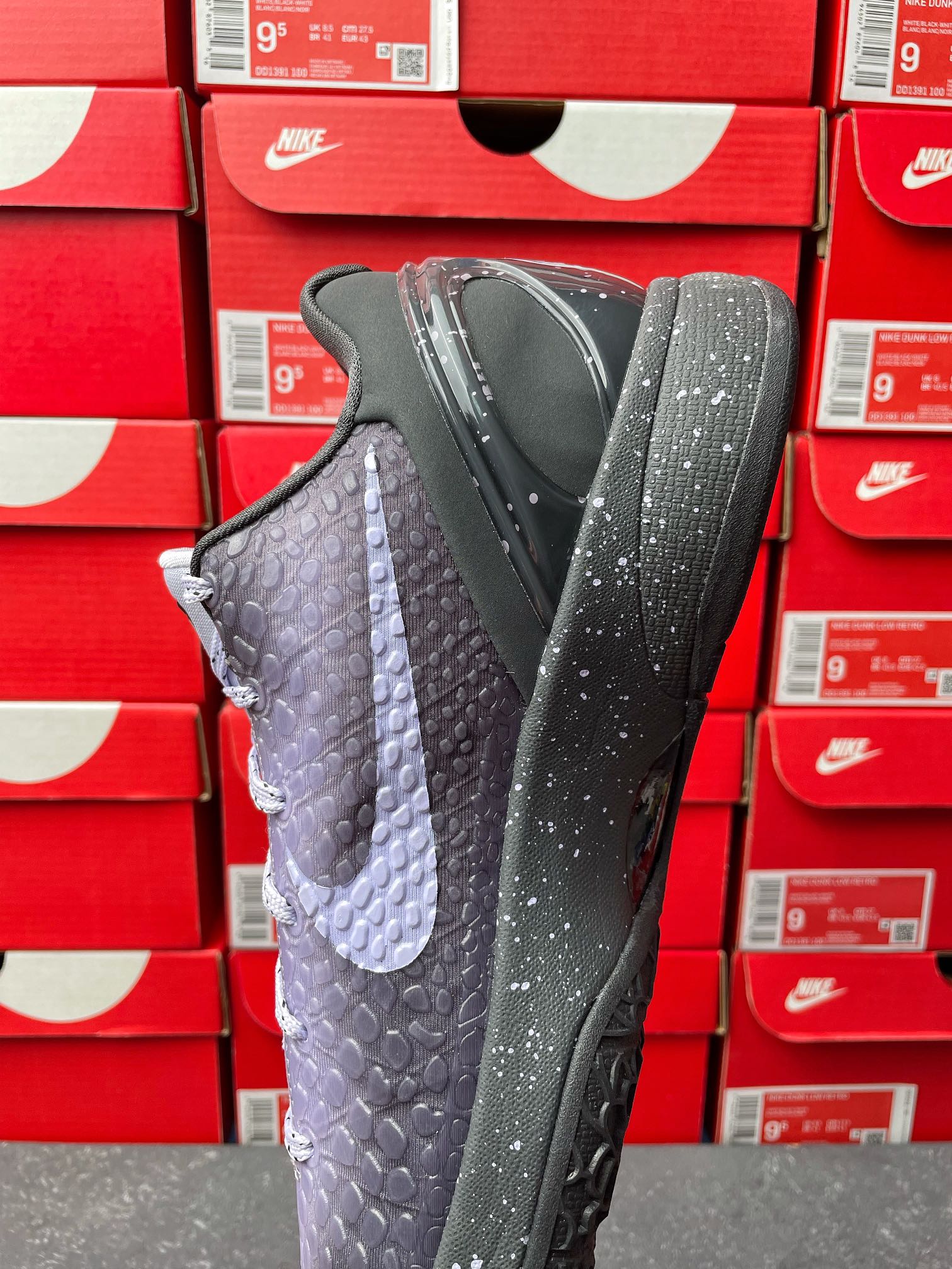 Basketball sneaker with dark gray and purple textured upper, lace-up design, side view.