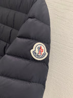 Moncler sleeve logo patch on dark quilted puffer jacket cuff