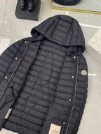 Moncler hooded puffer jacket in dark, quilted with metal snap front