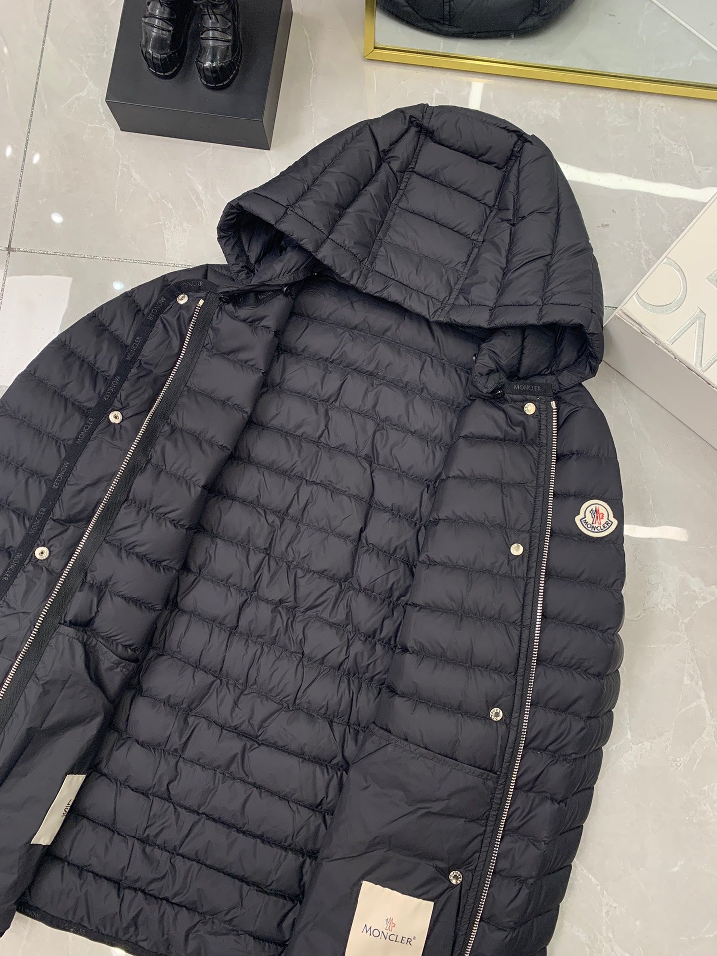 Moncler hooded puffer jacket in dark, quilted with metal snap front