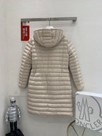 Long beige quilted puffer coat with hood, full-length zipper, and adjustable belt