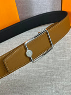 Tan leather belt with gold-tone buckle and round logo center detail