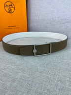 Hermes leather belt with olive strap, silver buckle, and embossed center button