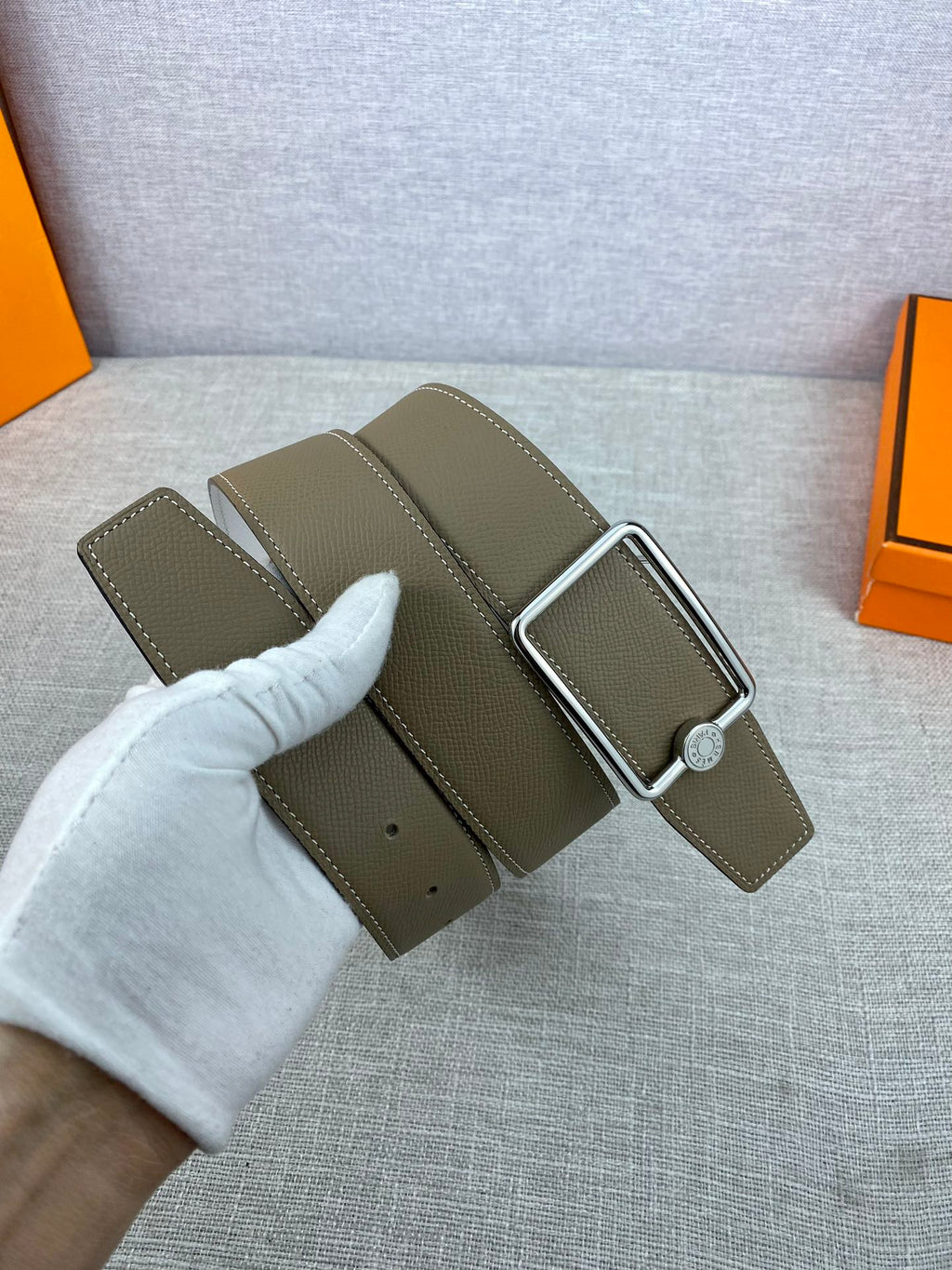 Hermes leather belt with olive strap and buckle shown with matching leather keeper