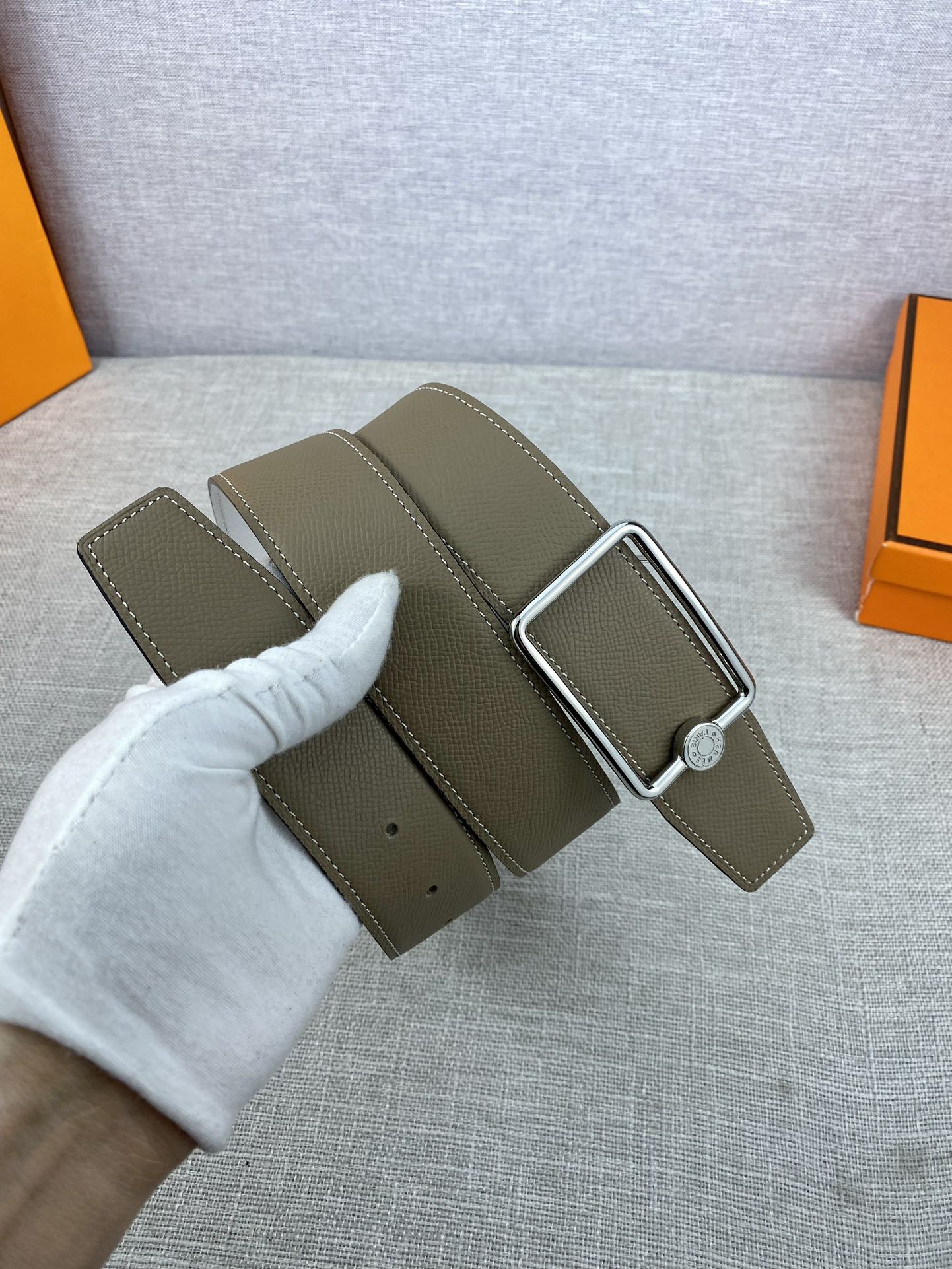 Hermes leather belt with olive strap and buckle shown with matching leather keeper