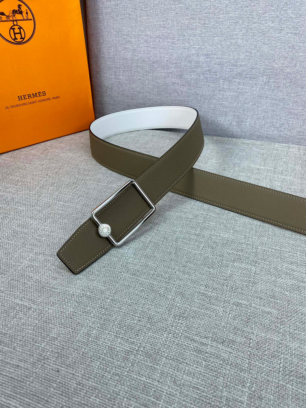 Hermes leather belt with olive strap and silver buckle with small round emblem
