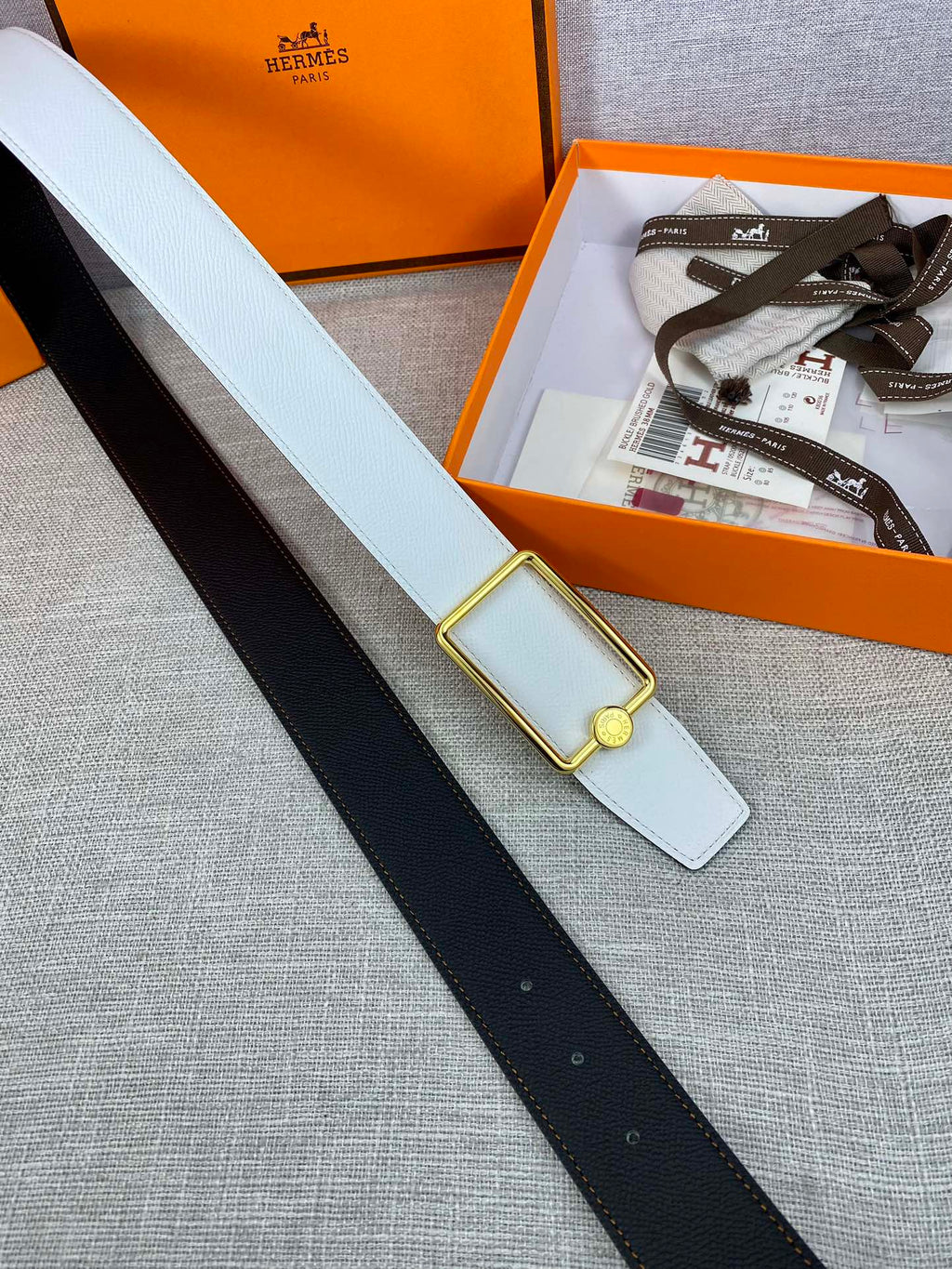 Light blue leather belt with gold buckle and keeper tab, shown with belt length.