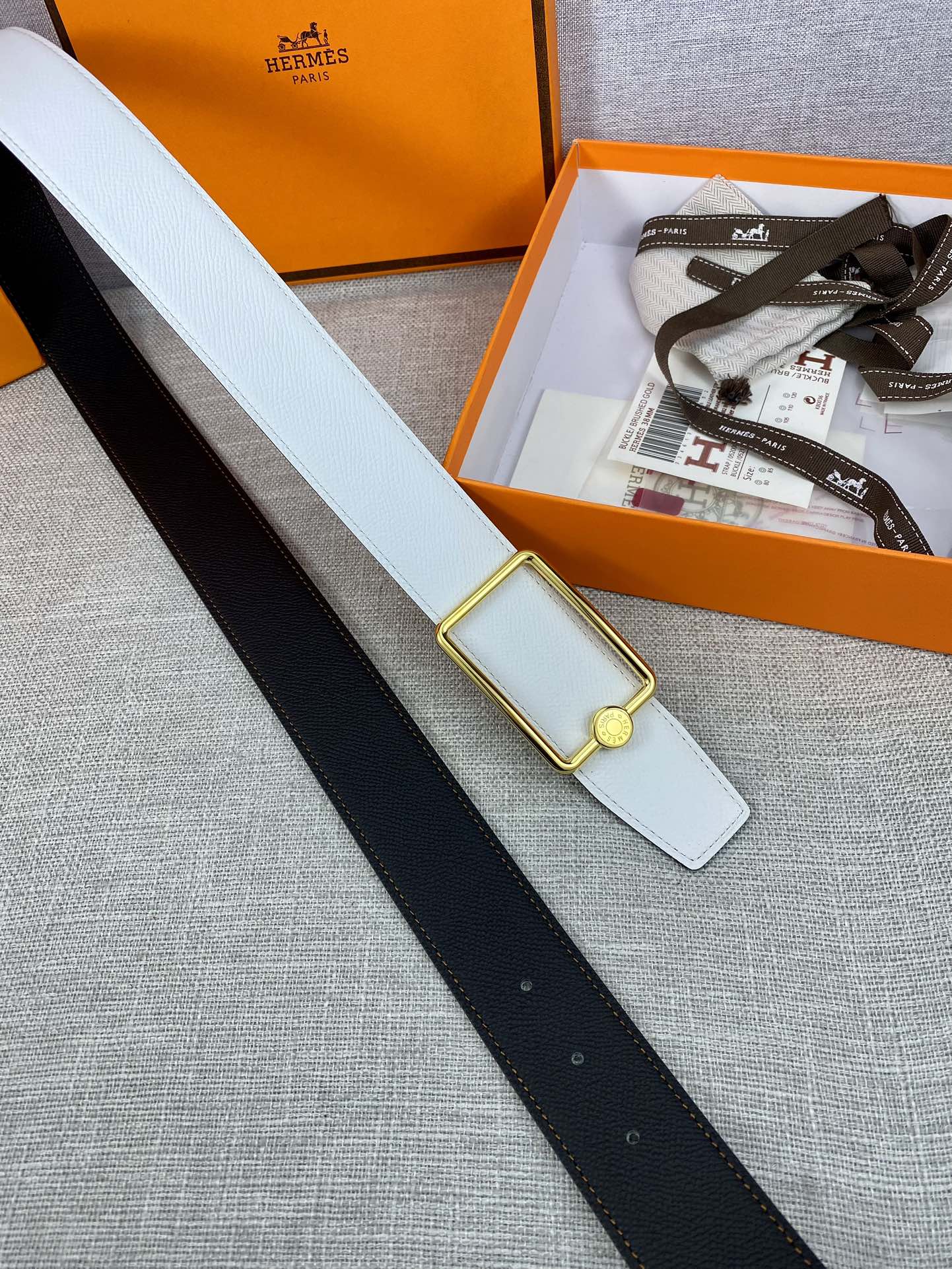 Light blue leather belt with gold buckle and keeper tab, shown with belt length.