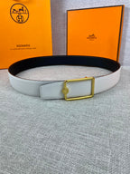 Light blue leather belt with gold rectangular buckle and matching keeper tab.