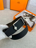Hermes belt in dark leather with silver rectangular buckle and round logo