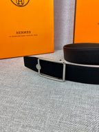 Hermes belt in dark leather with silver rectangular buckle and round emblem