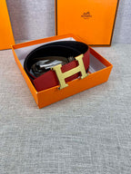 Hermes belt inside a gift box: red leather with gold-tone H buckle and black lining