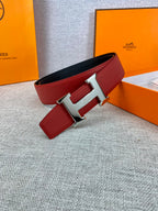 Hermes belt with red leather strap and silver H buckle, black underside visible