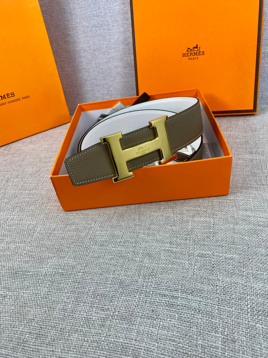 Leather belt in orange box, olive strap with gold-tone metal buckle