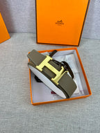 Olive leather belt with metal buckle and white protective paper inside box