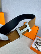 Hermes belt with tan leather strap and gold H buckle, dark underside shown