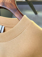 Tan Burberry T-shirt neckline with ribbed collar and shoulder seam