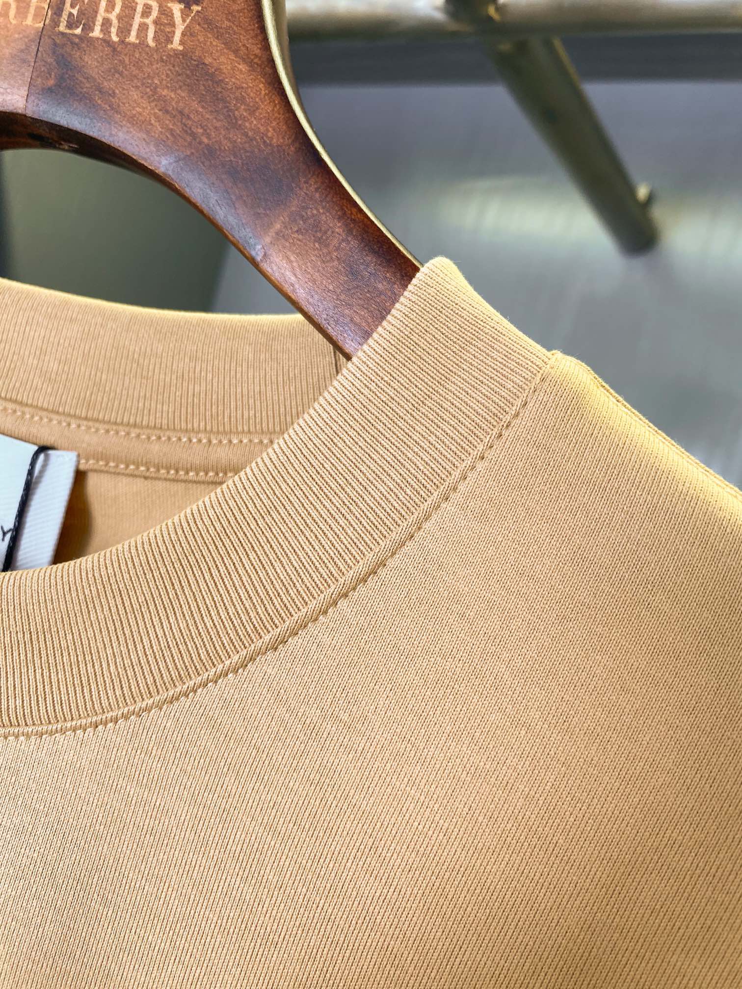 Tan Burberry T-shirt neckline with ribbed collar and shoulder seam