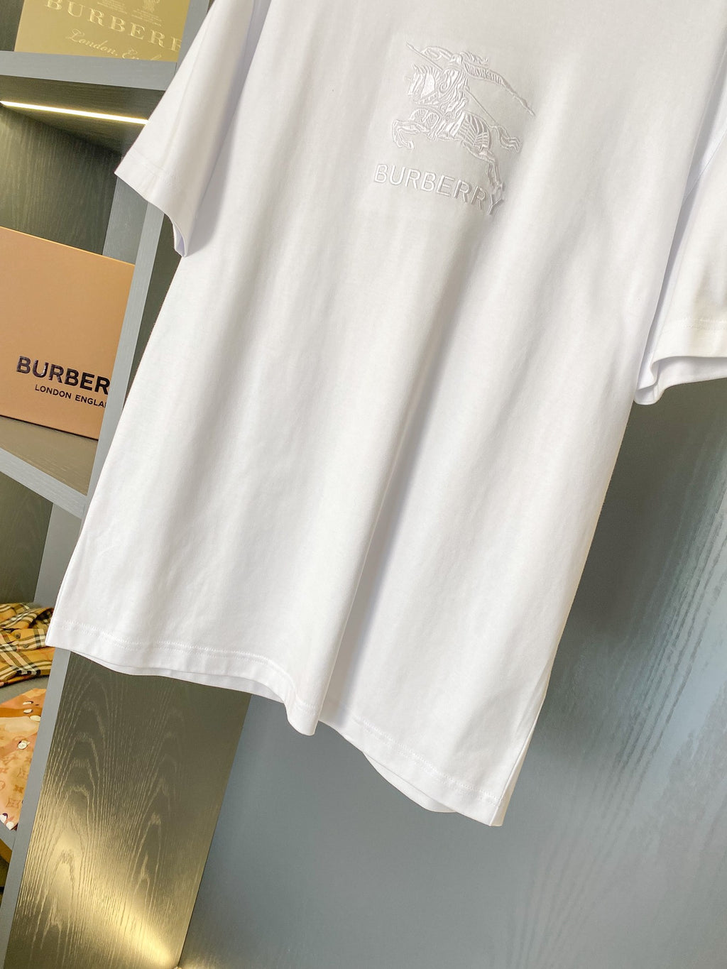 White T-shirt showing embossed Burberry logo and horse graphic on the front