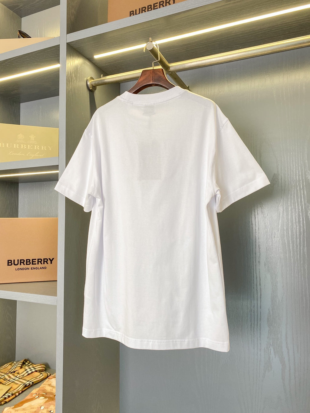 White short-sleeve crew-neck T-shirt hanging display with front logo graphic visible