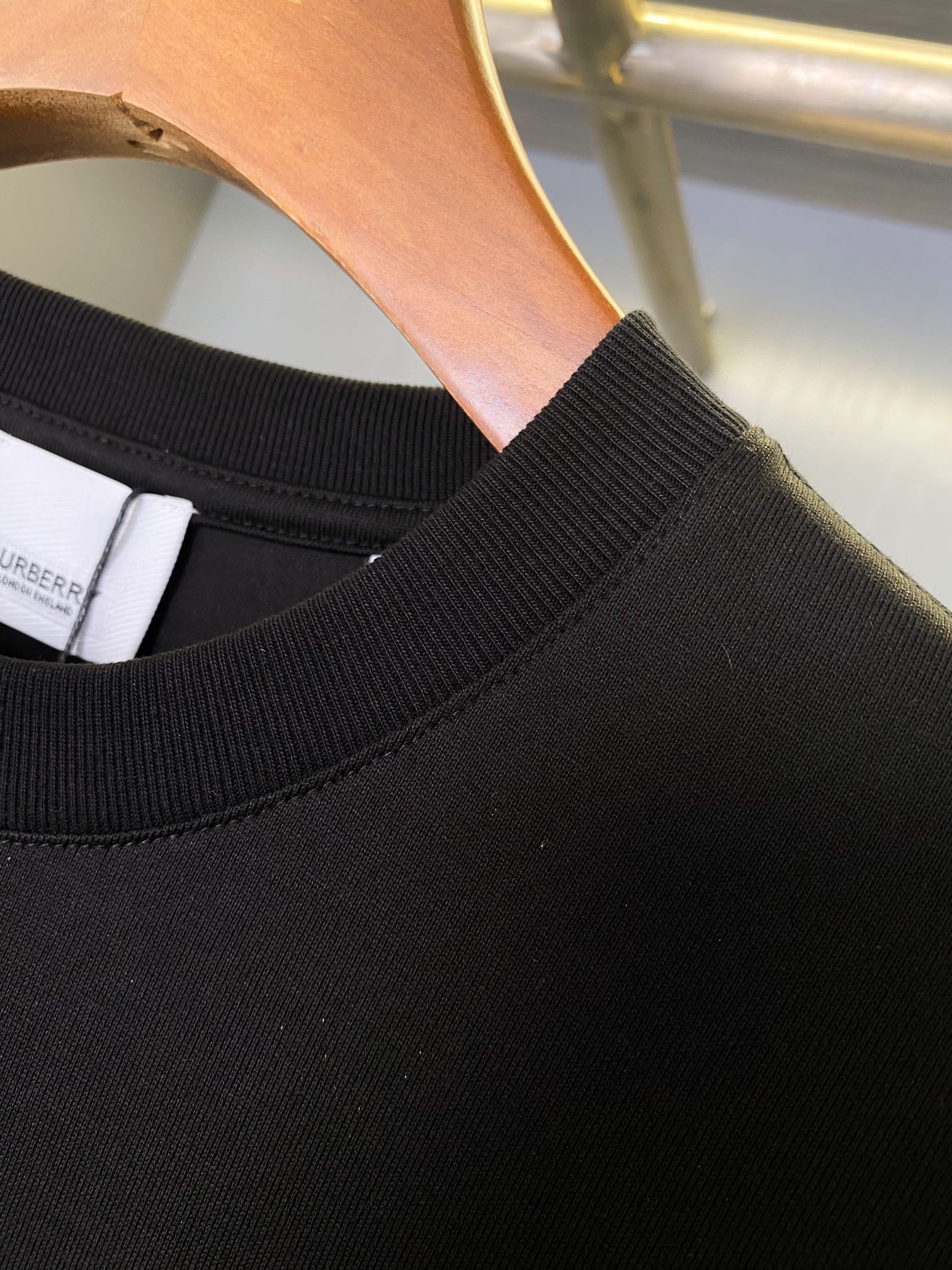 Black T-shirt neckline and ribbed crew neck collar detail
