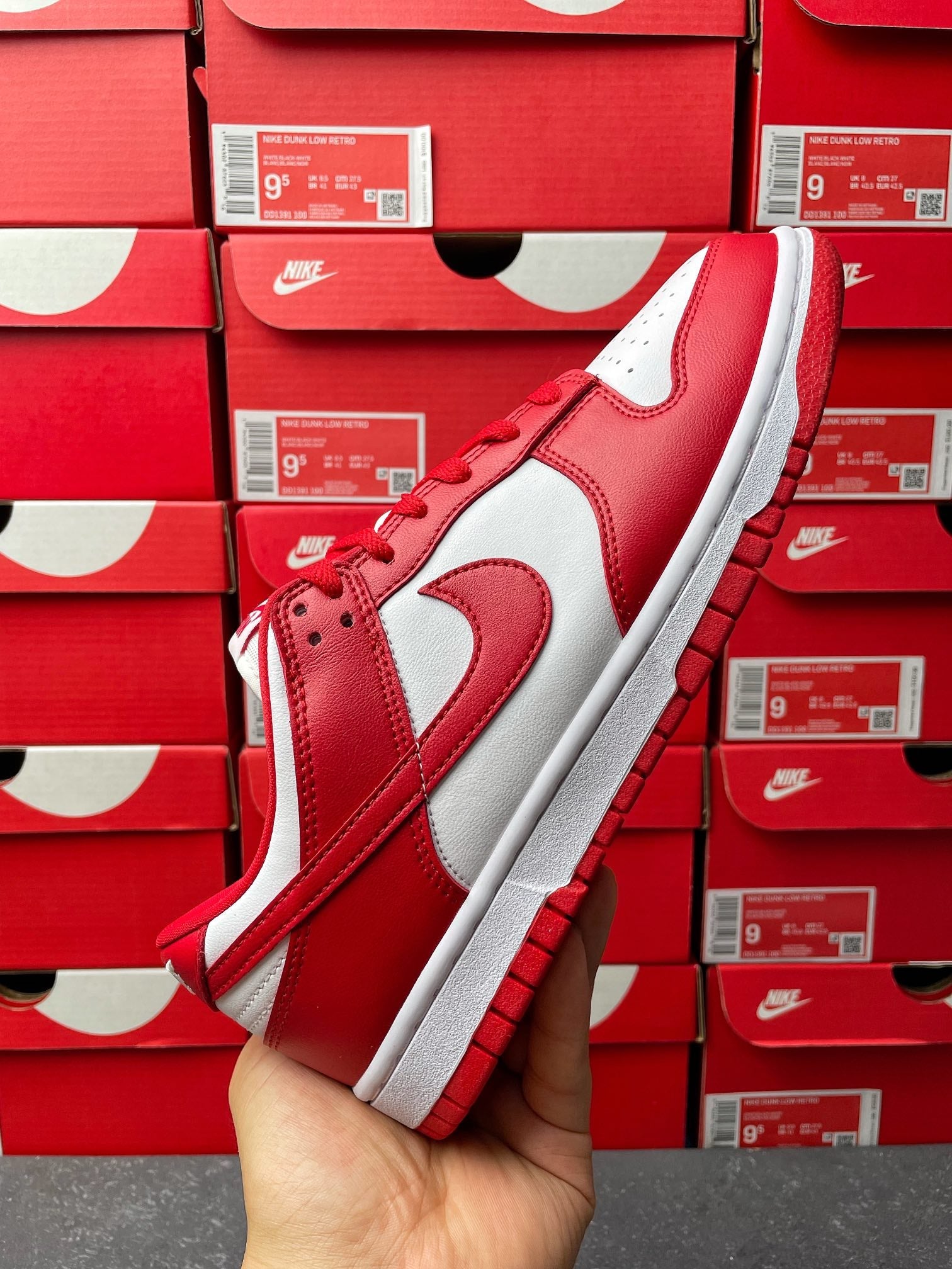 Nike Dunk Low low-top sneaker side view in red and white leather with white midsole