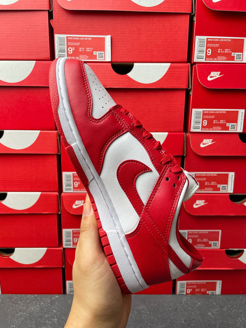 Nike Dunk Low low-top sneaker three-quarter view with red leather quarter and white swoosh
