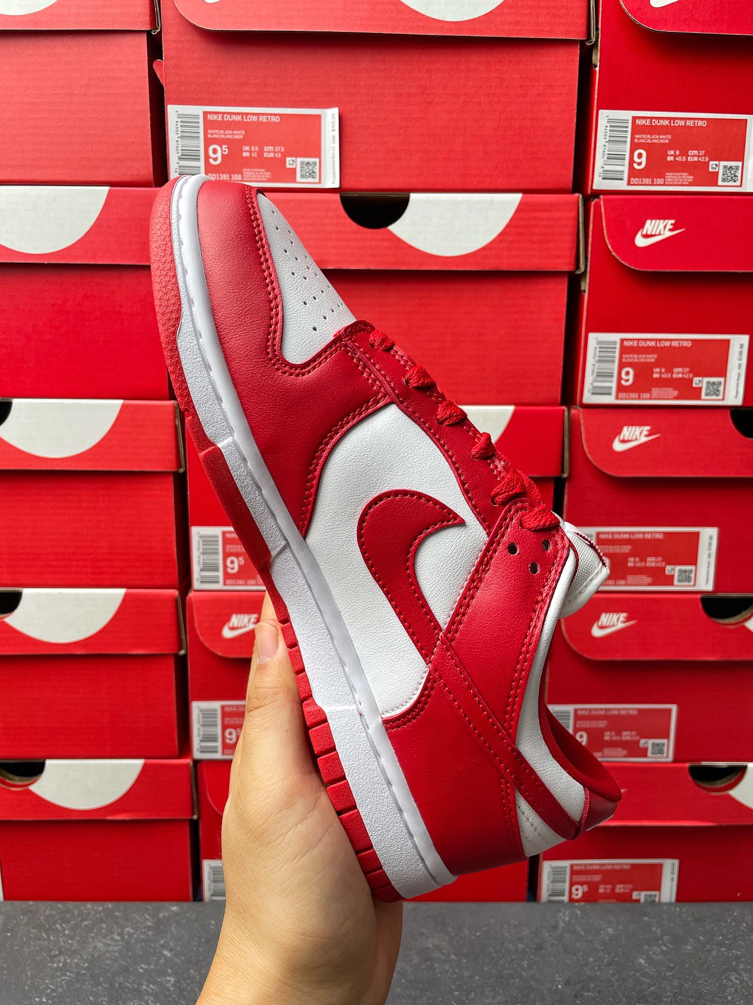 Nike Dunk Low low-top sneaker three-quarter view with red leather quarter and white swoosh
