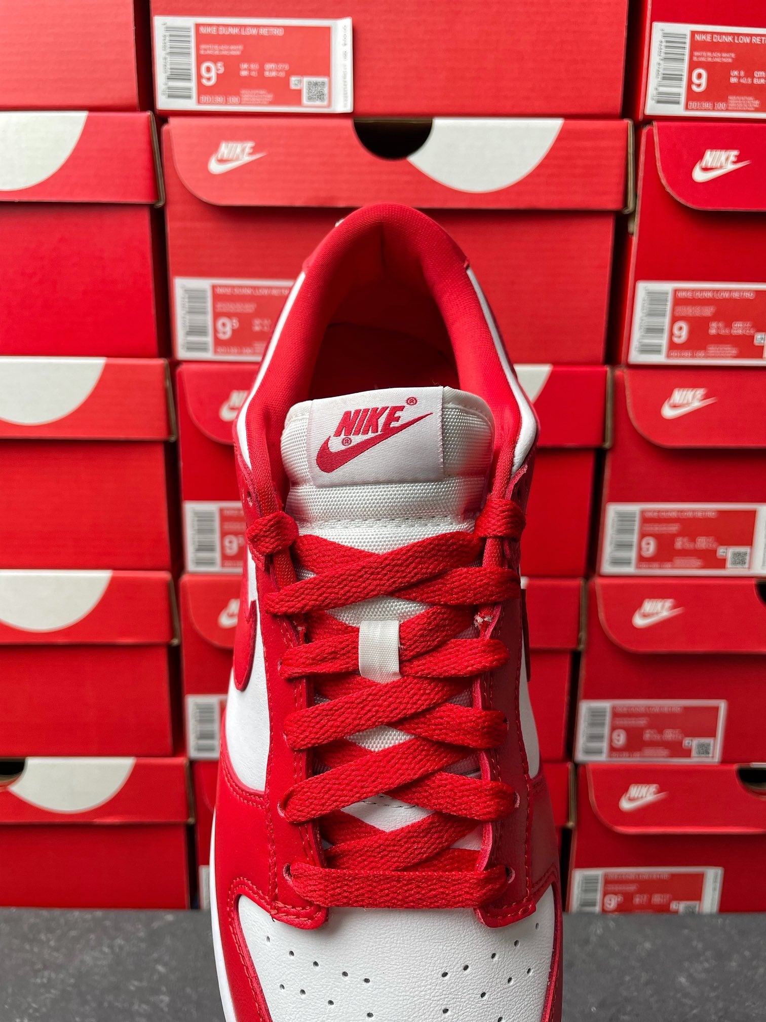 Nike Dunk Low low-top sneaker toe-up view with red laces and white mesh collar lining