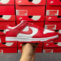 Nike Dunk Low low-top sneaker with red leather panels, white overlays, and red laces